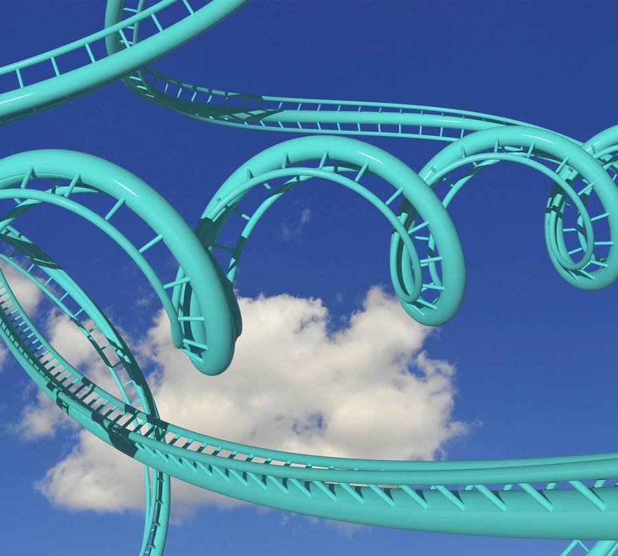 crazy rollercoaster trails against blue sky